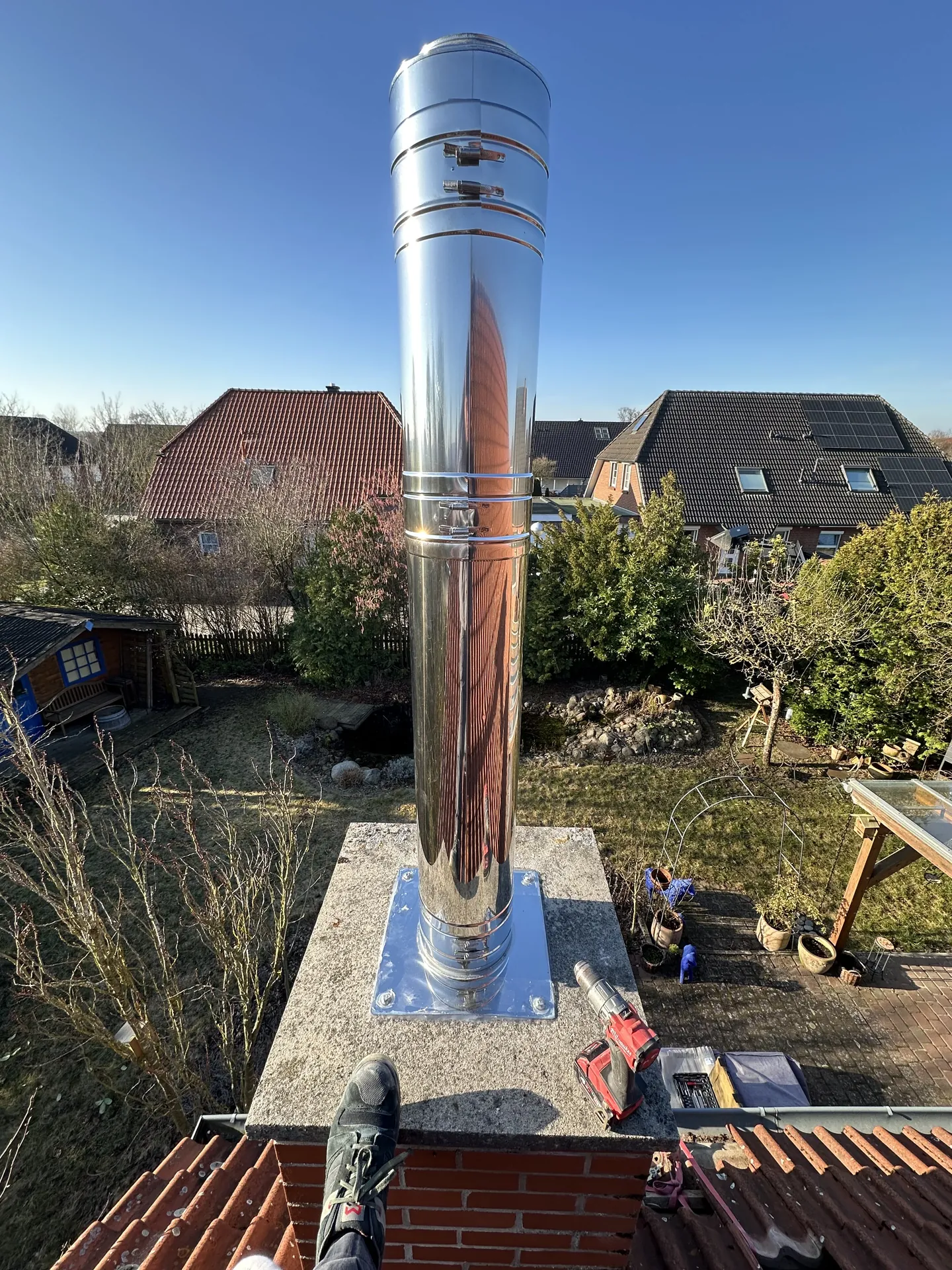 Stainless-steel chimney on a brick-built stack