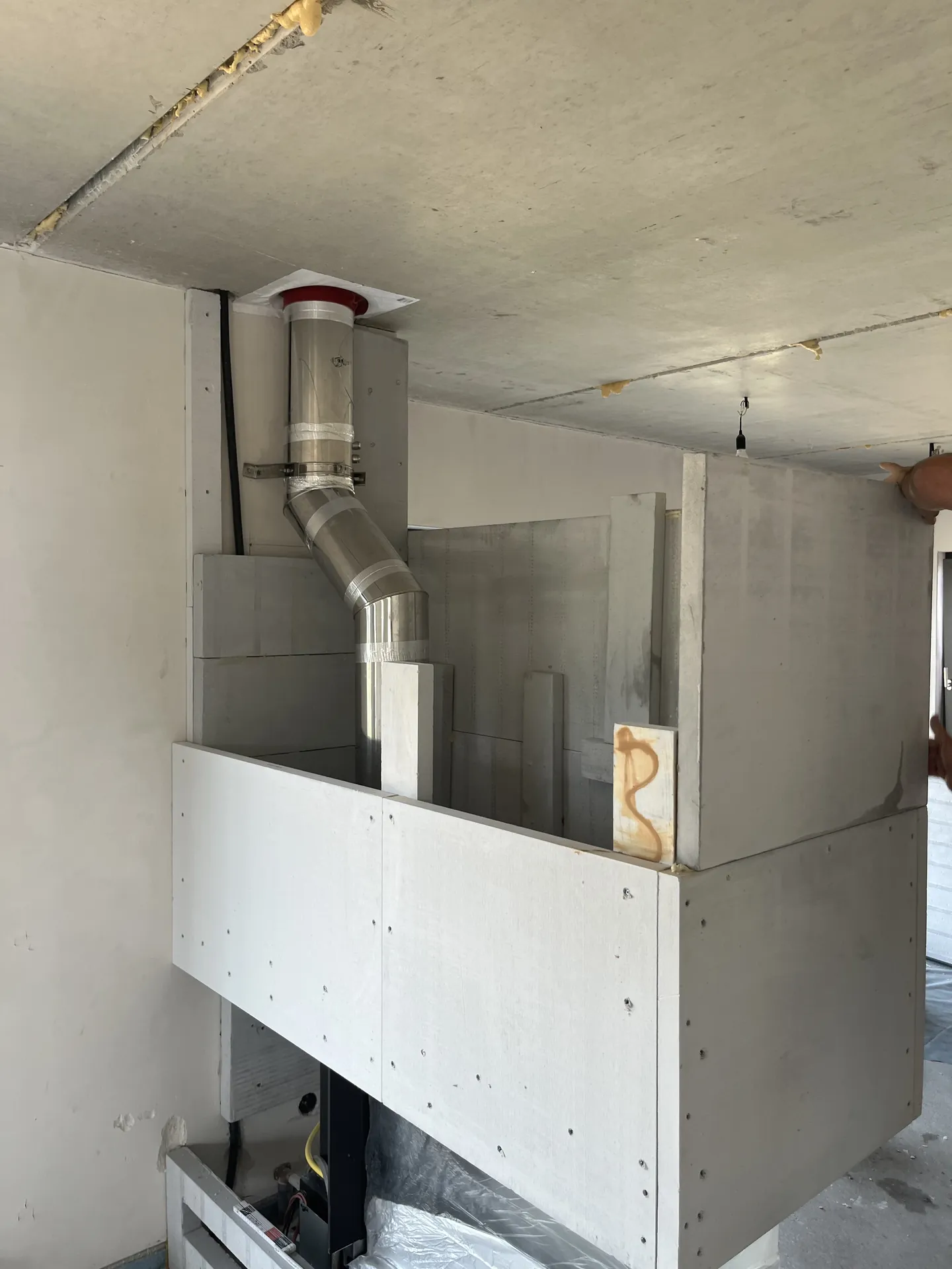 Built-in fireplace with flue pipe in a building shell